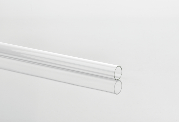 A clear glass tube reflected on a white background
