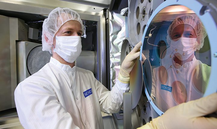 Scientist in a laboratory inspecting a glass coating