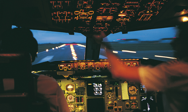 Interior of an aircraft cockpit with controls and displays