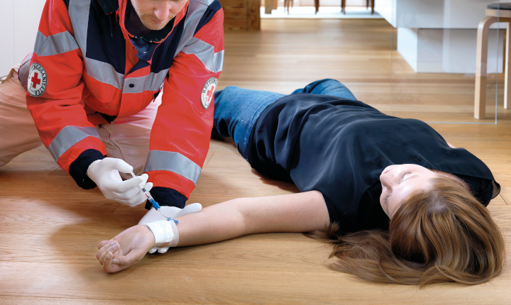 Male doctor injects a female patient with medication