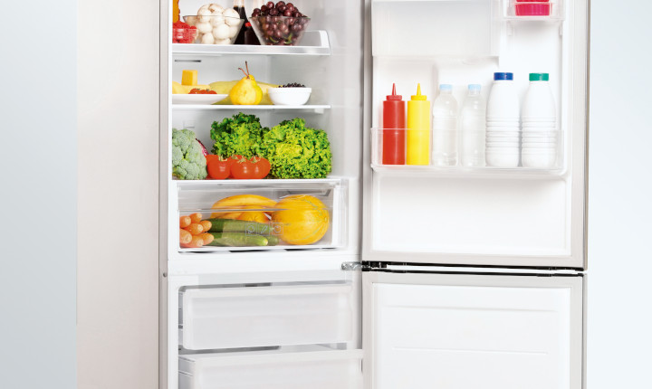 White refrigerator full of food with door open