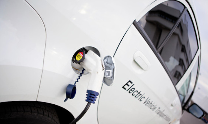 White electric vehicle being recharged