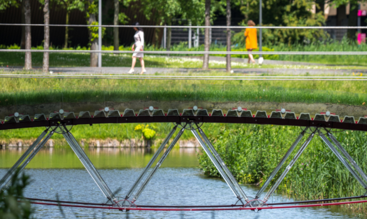 Bridge made of glass spanning a river on the campus of the Technical University of Delft in the Netherlands