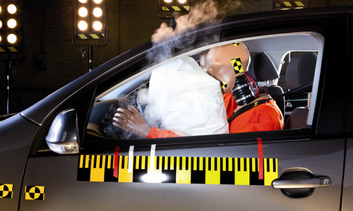 A crash test dummy involved in a vehicle collision with the airbag activated