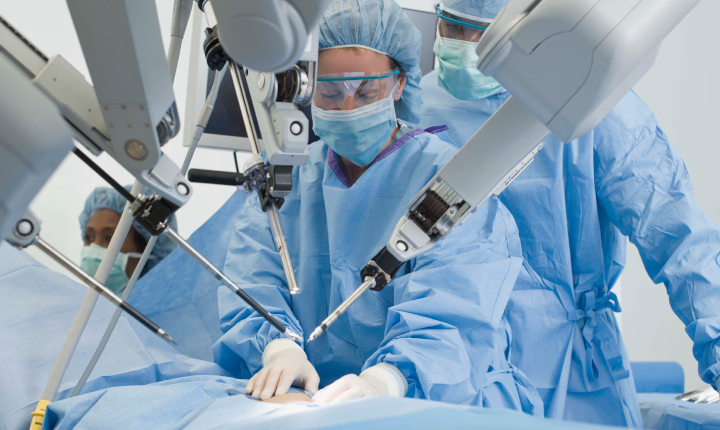 Surgeons operating on a patient using medical equipment with SCHOTT HermeS® TGV Wafers