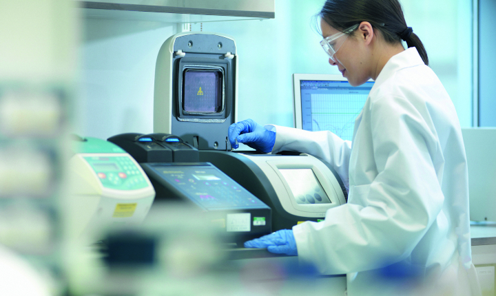 Female scientist working with diagnostics equipment in a laboratory