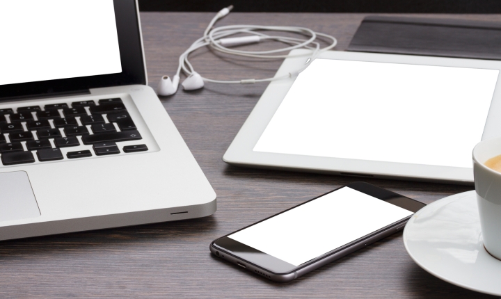 Silver laptop, tablet and smartphone devices on a desk