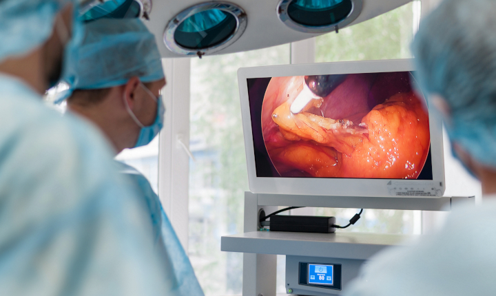 Surgeon in a hospital operating theater looking at an image on a display