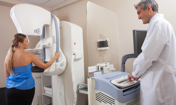 Female patient being scanned by a hospital x-ray machine	