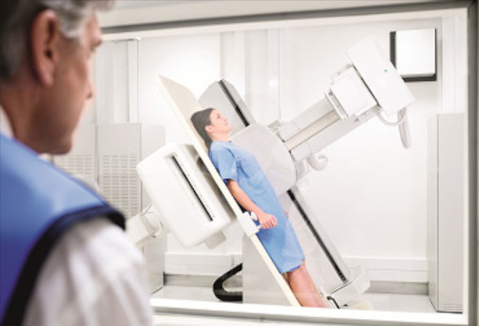 Female patient being scanned by a hospital x-ray machine
