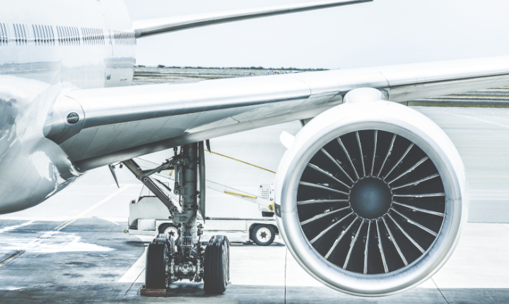 Commercial airplane on runway with front view of engine 