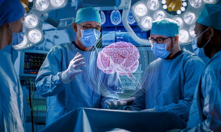 Two surgeons with augmented reality glasses manipulating an image of the human brain