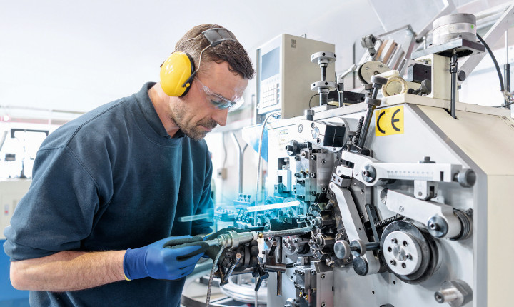 Man with augmented reality glasses working on an industrial machine 