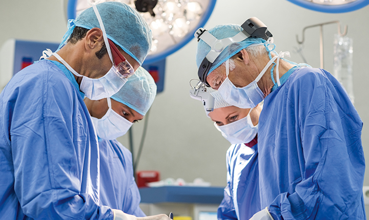 A team of surgeons working in a hospital operating theater