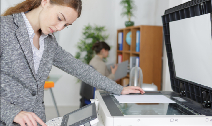 Female operating an office photocopier