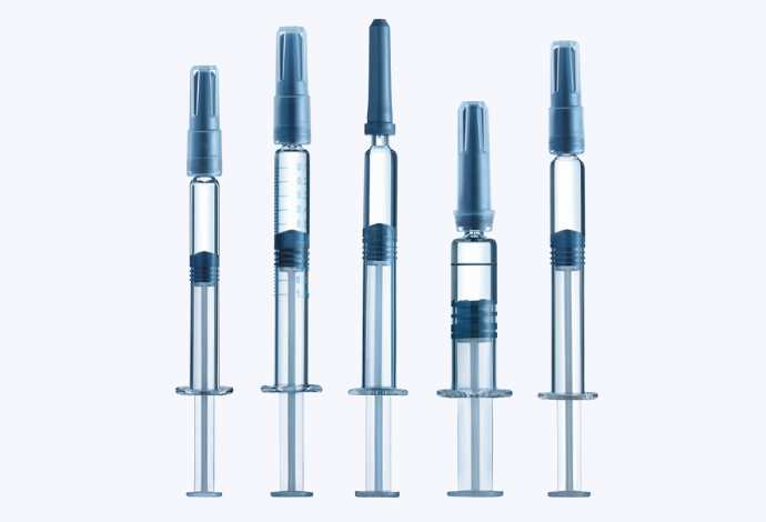 A row of five clear glass syringes made by SCHOTT
