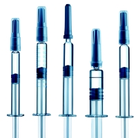 A row of five different types of clear glass syringe made by SCHOTT