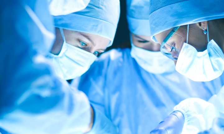 Three doctors working in a hospital operating theater