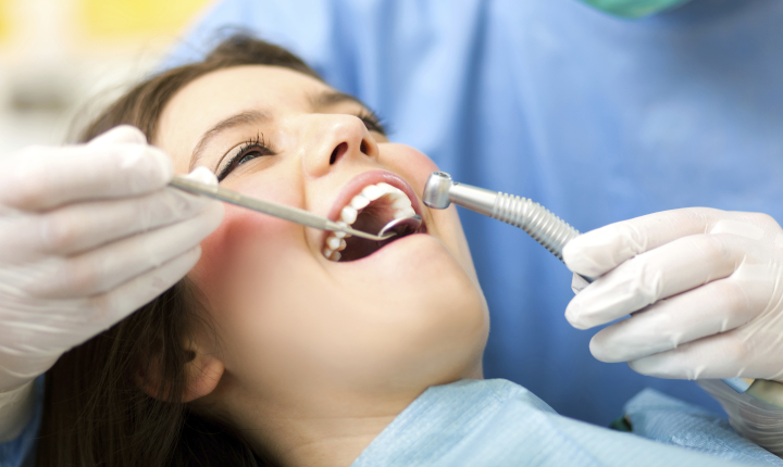 Female patient being examined by a dentist