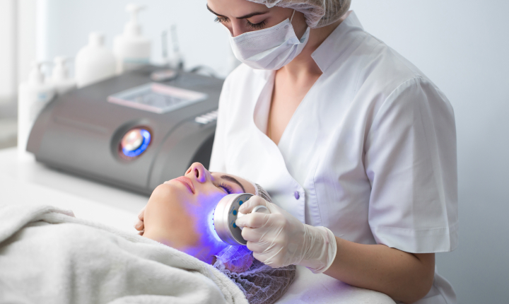 Ultrasonic massager used on the face of a woman in a beauty salon