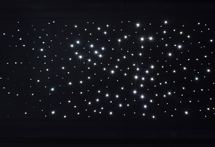 Close up of an aircraft cabin ceiling lit up by the SCHOTT Star Ceiling lighting system
