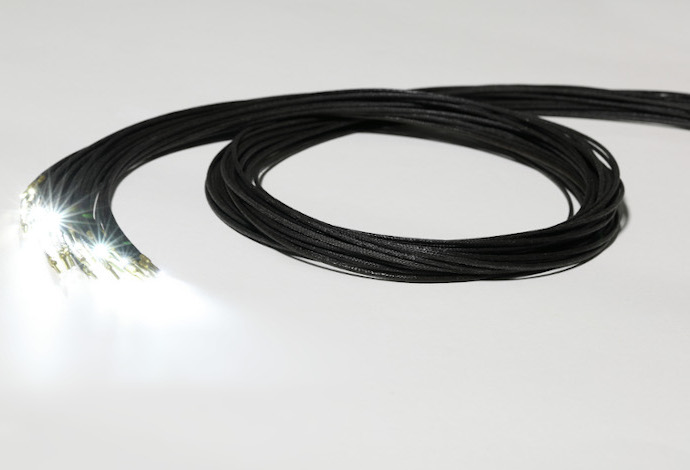 Bundle of black fiber optic guides as part of the SCHOTT Star Ceiling lighting platform for aircraft