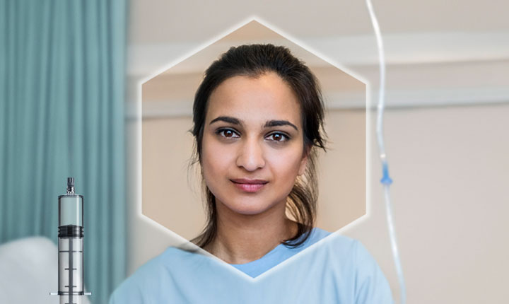 Female head shot staring at camera with SCHOTT TOPPAC® syringe in foreground