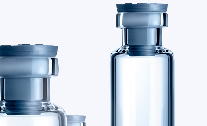 Three clear pharmaceutical glass vials made by SCHOTT