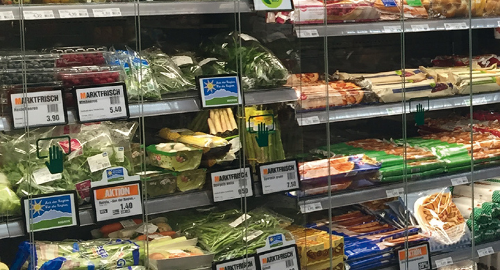 SCHOTT delivers energy-efficient glass for commercial refrigeration systems Line of refrigerators inside a supermarket with clear glass fronts