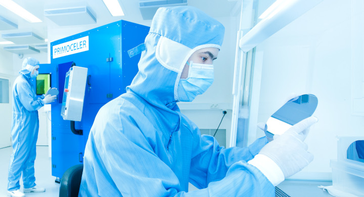 SCHOTT offers a range of packaging components and materials for MEMS Two scientists working in a laboratory looking at mirror discs