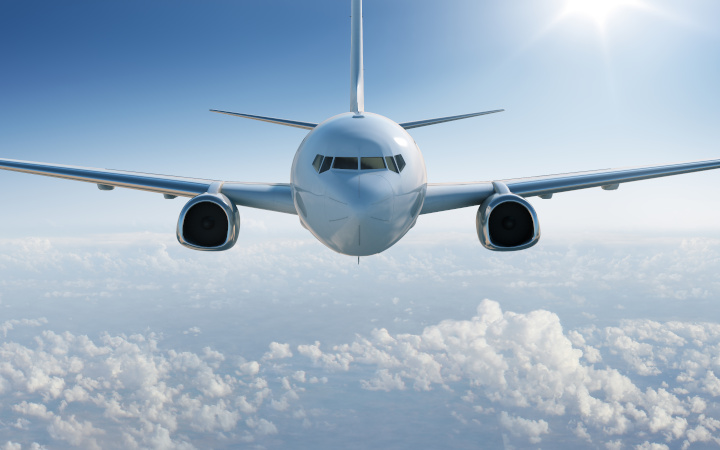 Front view of an aircraft in a blue sky