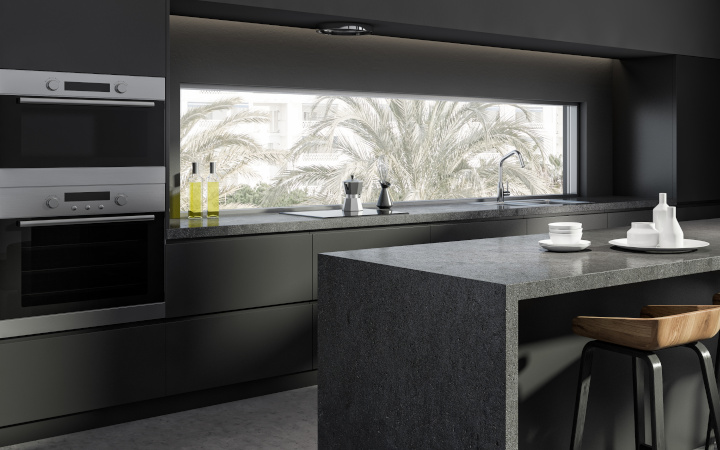 Sleek dark modern domestic kitchen with a range of appliances