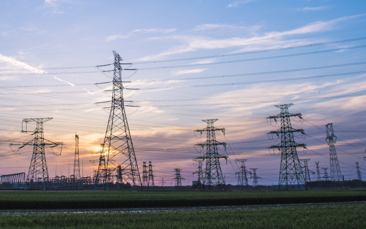 Rows of electrical pylons with sunset background
