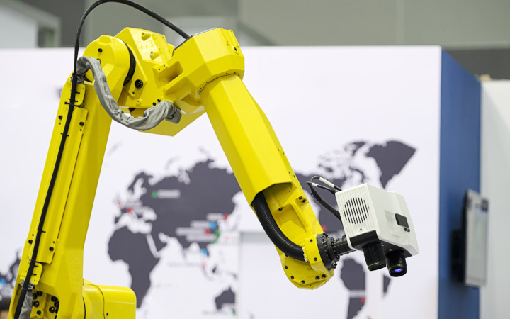Yellow robot arm with camera attached