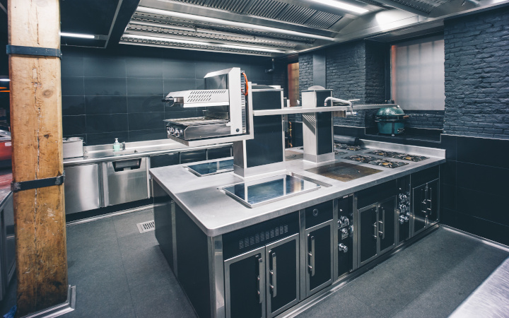 Modern professional kitchen with a range of cooktops and ovens
