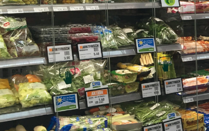Line of refrigerators inside a supermarket with clear glass fronts