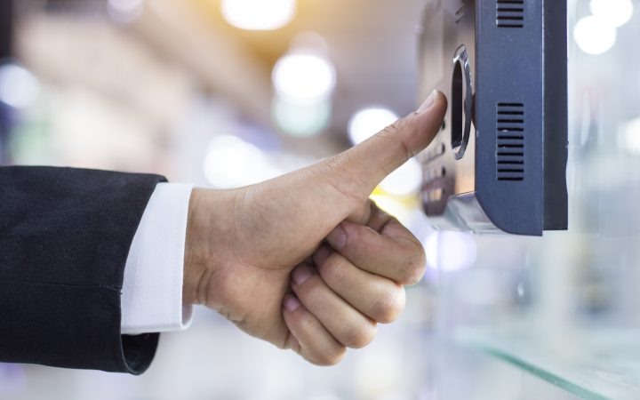 Thumb poised over a fingerprint touchscreen security system