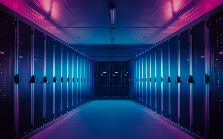 Row of high performance computers bathed in purple light