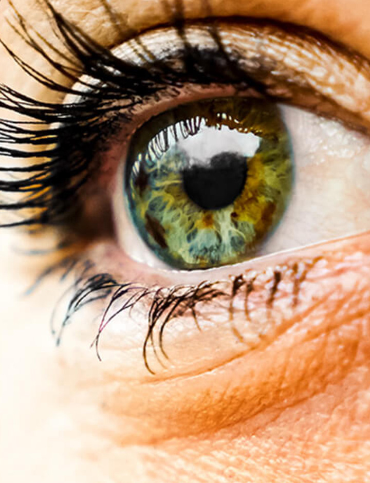 Female eye looking at the orange surface of the sun