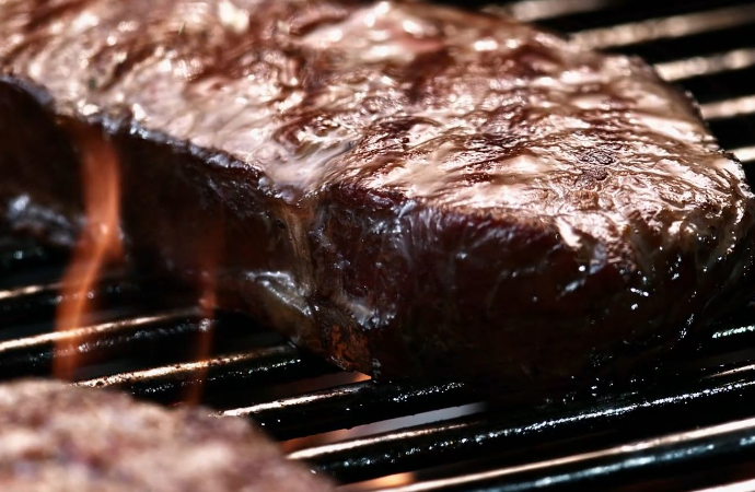 Cooked steak on a flame grill
